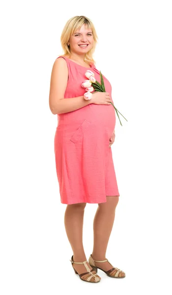 Zwangere vrouw met bloemen in rode jurk — Stockfoto