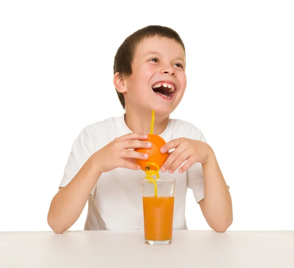 Little boy with orange juice — Stock Photo, Image