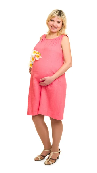 Pregnant woman with flowers in red dress — Stock Photo, Image