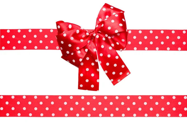 Red bow and ribbon with white polka dots made from silk — Stock Photo, Image