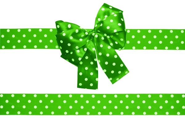 Green bow and ribbon with white polka dots made from silk — Stock Photo, Image