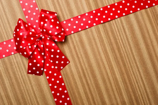 Red bow on wood background — Stock Photo, Image