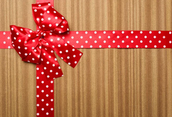 Red bow on wood background — Stock Photo, Image