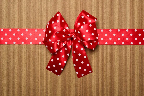 Red bow on wood background — Stock Photo, Image