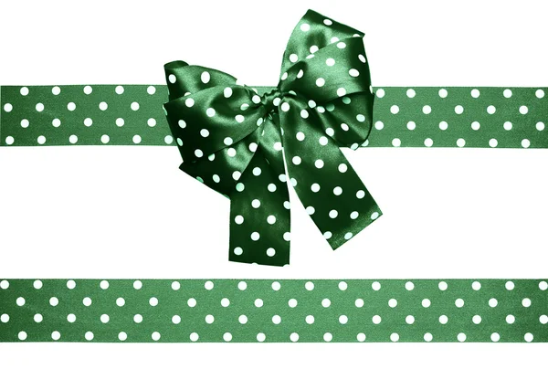 Green bow and ribbon with white polka dots made from silk — Stock Photo, Image