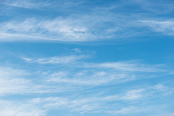 Blue sky background with soft white clouds 