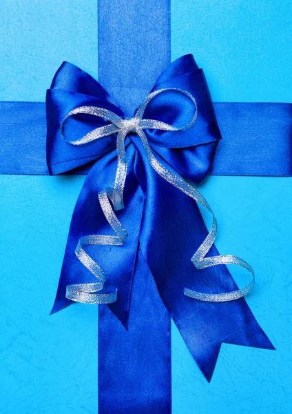 Blue bow made from silk on cyan — Stock Photo, Image