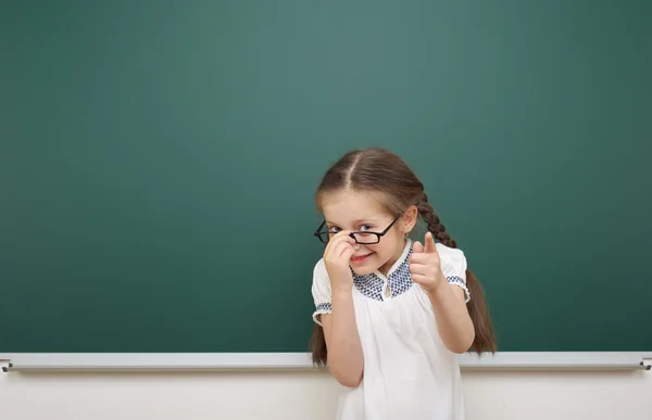 Schoolgirl near school board — Stock Photo, Image