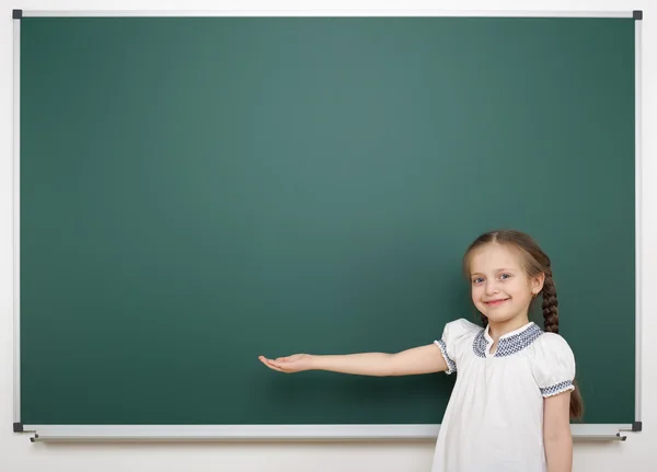 Schoolgirl near school board — Stock Photo, Image