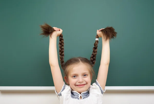 Schoolgirl near school board — Stock Photo, Image