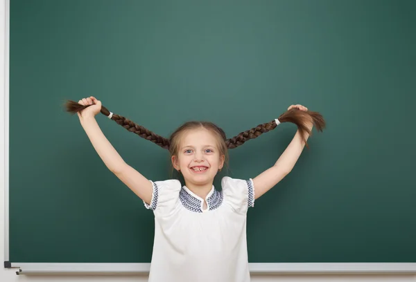 Schoolgirl near school board — Stock Photo, Image