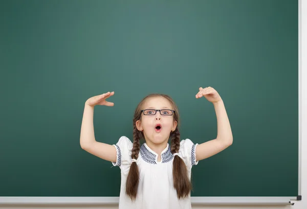 Schoolgirl near school board — Stock Photo, Image