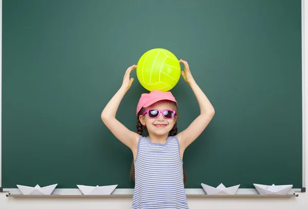 Schoolgirl near school board — Stock Photo, Image