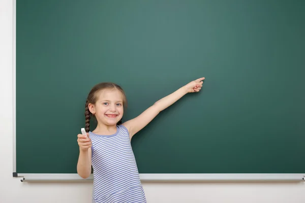 Schoolgirl near school board — Stock Photo, Image