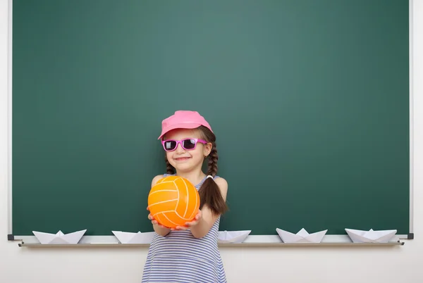 Schoolgirl near school board — Stock Photo, Image