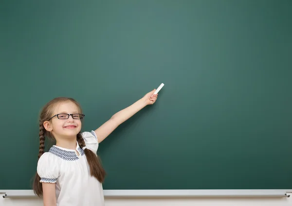 Schoolgirl near school board — Stock Photo, Image