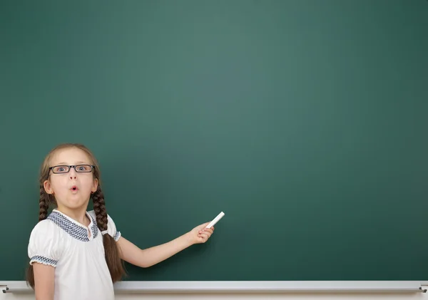 Schoolgirl near school board — Stock Photo, Image