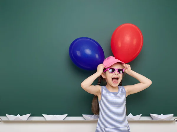 Girl with balloon near school board — Stock Photo, Image