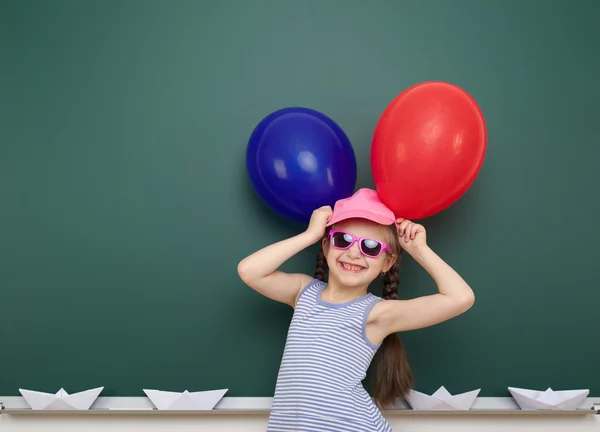 Girl with balloon near school board — Stock Photo, Image