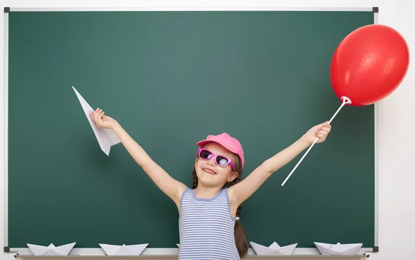 Schoolgirl near school board — Stock Photo, Image