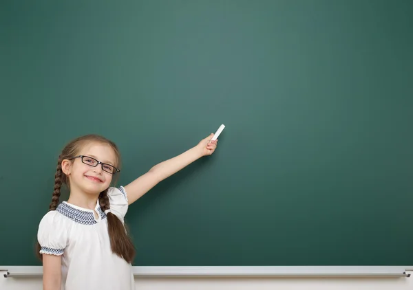 Schoolgirl near school board — Stock Photo, Image