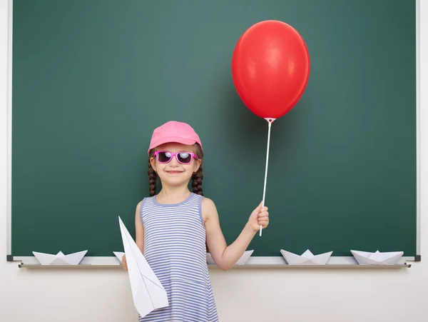 Schoolgirl near school board — Stock Photo, Image