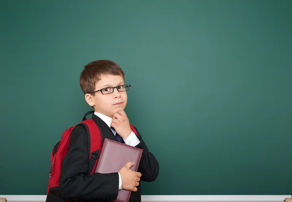 Schoolboy with backpack on school board background — Stock Photo, Image