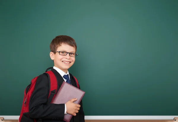 Schoolboy com mochila no fundo do conselho escolar — Fotografia de Stock