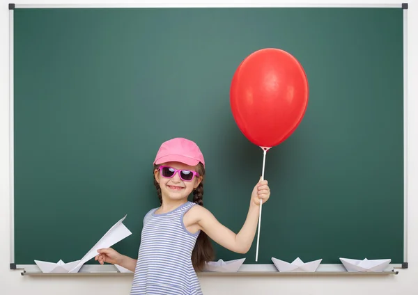 Schoolgirl near school board — Stock Photo, Image