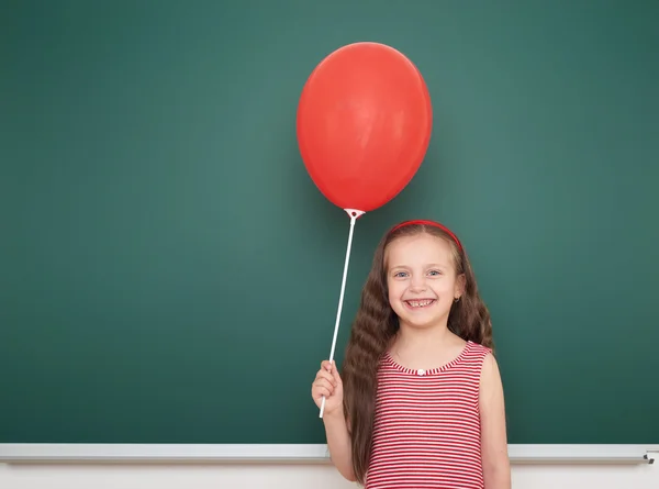 Girl with balloon near school board — Stock Photo, Image