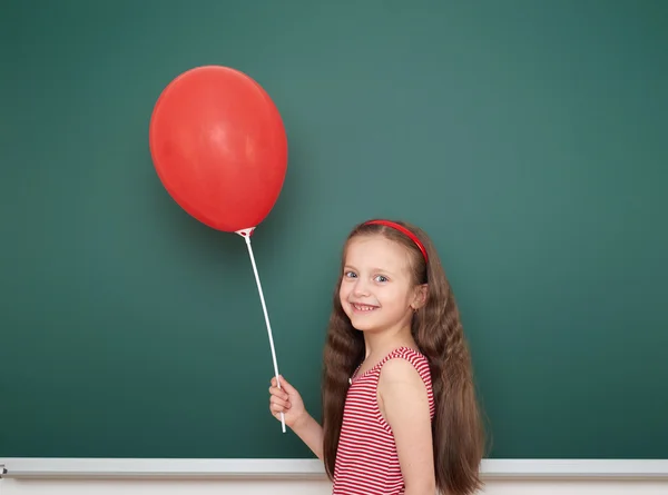 Girl with balloon near school board — Stock Photo, Image