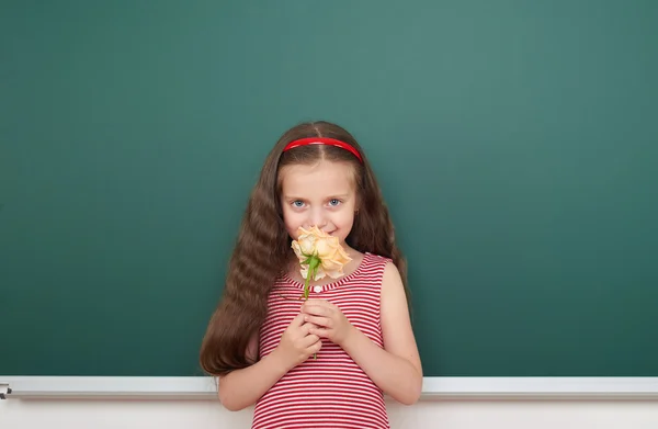 Girl with rose flower near school board — Stock Photo, Image