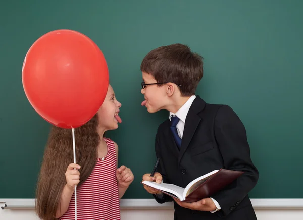 Boy and girl near school board — Stock Photo, Image