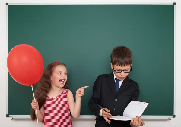 Ragazzo e ragazza vicino consiglio scolastico — Foto Stock