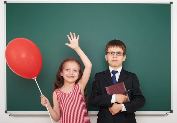 Boy and girl near school board — Stock Photo, Image