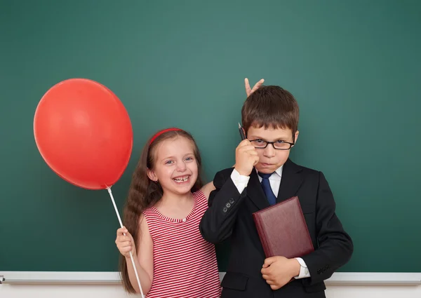 Boy and girl near school board — Stock Photo, Image