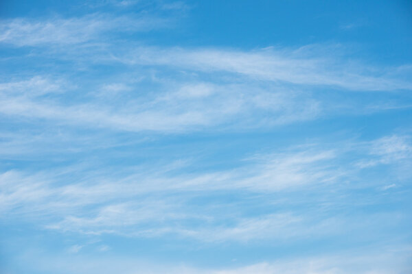 Blue sky background with soft white clouds 