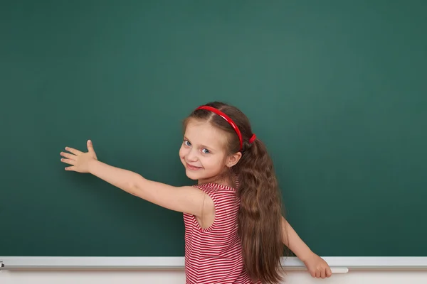 Schoolgirl write on school board Royalty Free Stock Images