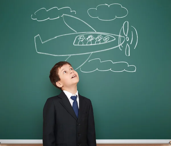 Boy in suit look on plane sketch on board — Stock Photo, Image