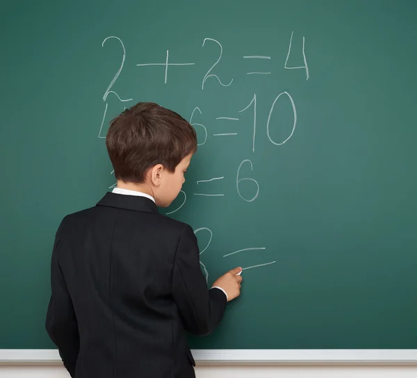 School boy solve math on school board — Stock Photo, Image