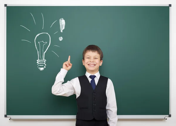 School boy with painted lightbulb having idea — Stock Photo, Image