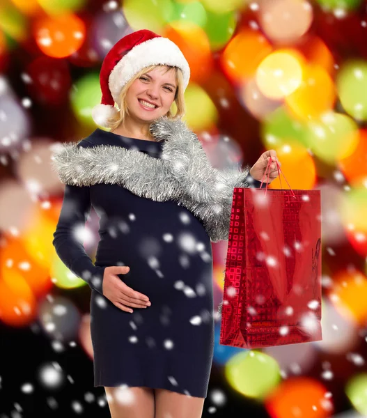 Kerst vakantie zwangere vrouw in Kerstman hoed — Stockfoto