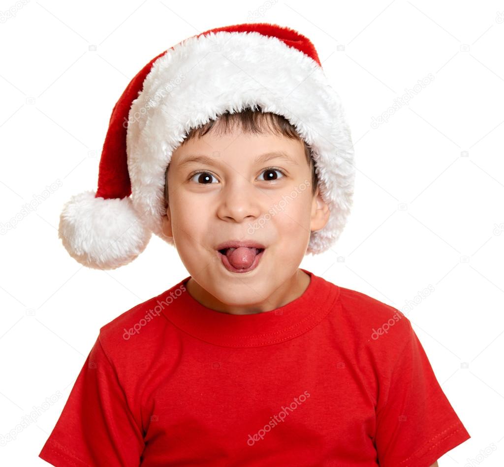 winter holiday christmas concept - boy in santa hat portrait on white show tongue