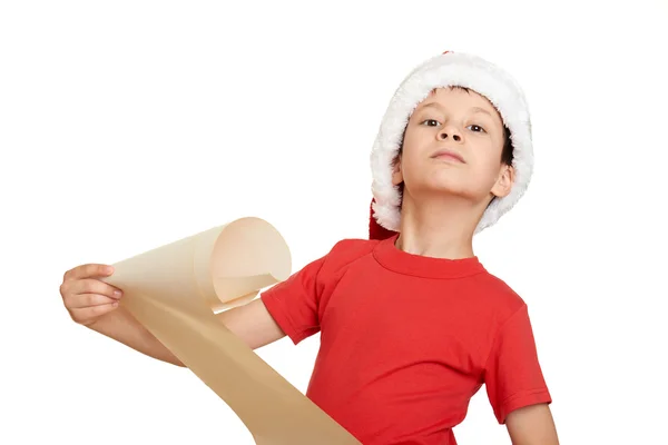 Boy in red hat with long scroll wishes to santa - winter holiday christmas concept — Stock Photo, Image