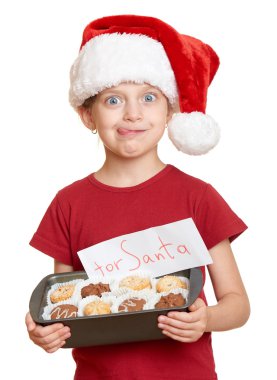 Çerezler ile Noel Baba şapkalı kız kendini - kış tatil Noel kavramı yalamak