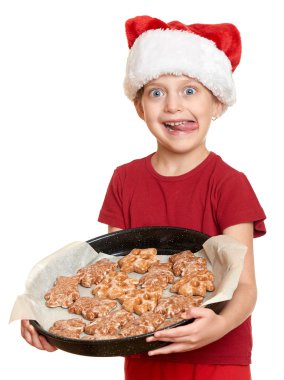 Noel Baba şapkalı kız kurabiye yemek ve kendini - kış tatil Noel kavramı yalamak