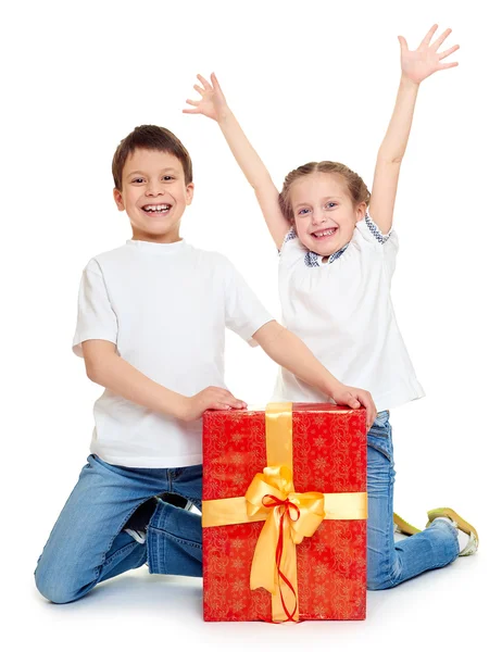 Menino e menina com caixa de presente vermelho e arco dourado - conceito de objeto de férias isolado — Fotografia de Stock