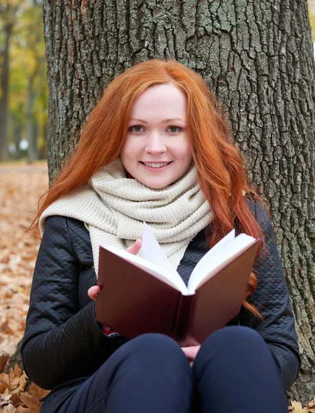 Redhead girl read book in city park, fall season — Stock Photo, Image