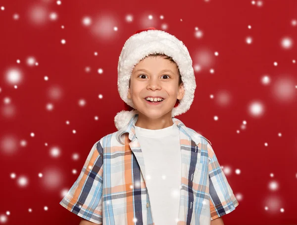 Winter holiday christmas concept - boy in santa hat portrait on Stock Photo