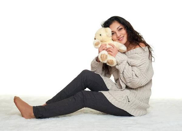 Girl with teddy bear sit on fur, white background — Stock Photo, Image